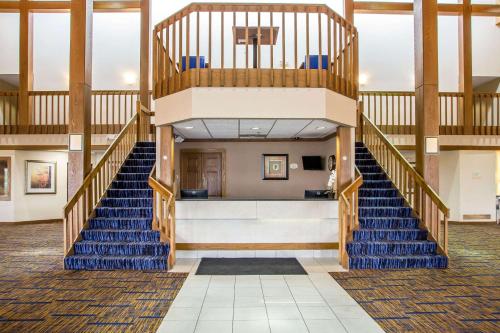a staircase in a building with blue stairs at Clarion Inn in Merrillville