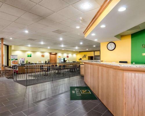 a fast food restaurant with a bar and a clock at Quality Inn Liberal in Liberal