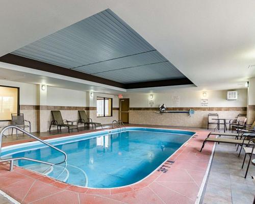 a swimming pool with a pool table and chairs at Comfort Inn & Suites Lawrence in Lawrence