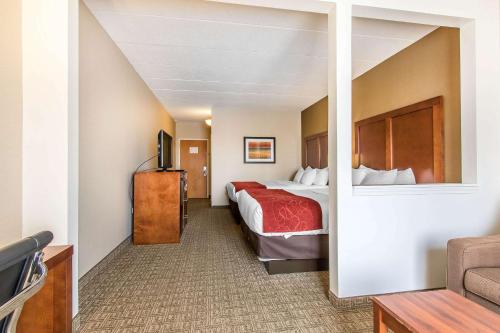 a hotel room with a bed and a tv at Comfort Suites in Richmond