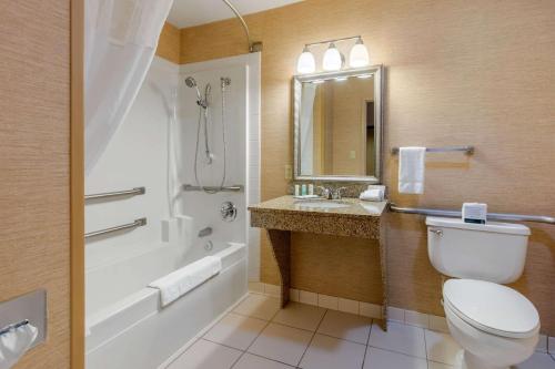 a bathroom with a toilet and a shower and a sink at Quality Inn & Suites Benton - Draffenville in Draffenville