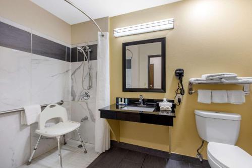 a bathroom with a sink and a toilet and a mirror at Quality Inn in Cadiz