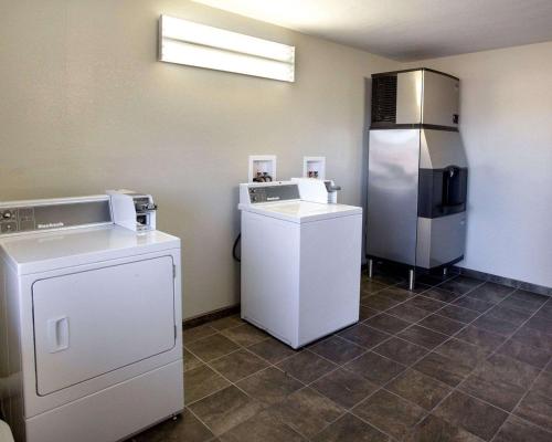 a laundry room with a refrigerator and a washer at Quality Inn Hammond in Hammond