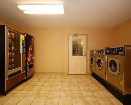 a laundry room with a washer and dryer at Suburban Studios Avondale in Avondale