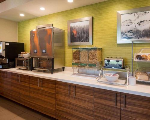 a kitchen with a counter with some food on it at Comfort Suites Bossier City - Shreveport East in Bossier City