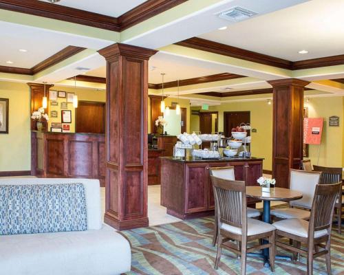 a living room with a couch and a table at Comfort Suites Harvey - New Orleans West in Harvey