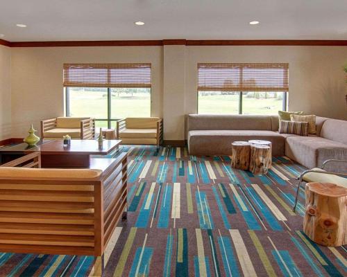 a living room with a couch and a table at Comfort Suites Bossier City - Shreveport East in Bossier City