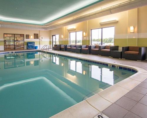 a large pool in a hotel room with couches at Comfort Suites Bossier City - Shreveport East in Bossier City