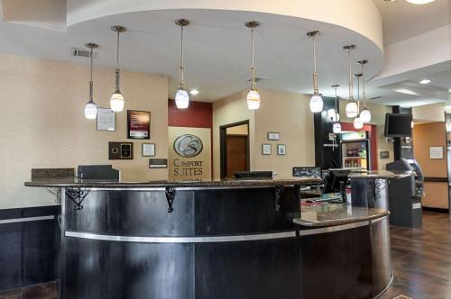 a bar in a hotel lobby with pendant lights at Comfort Suites Sulphur-Lake Charles in Sulphur
