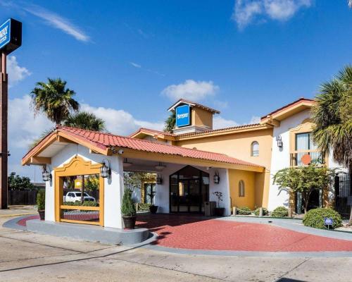 a house with a red driveway in front of it at Sunrise Inn & Suites New Orleans in New Orleans