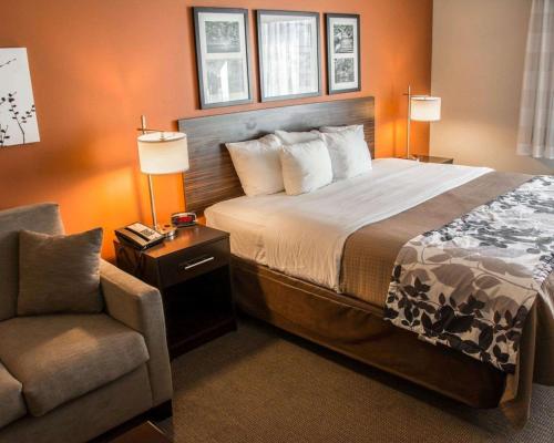 a hotel room with a bed and a chair at Sleep Inn & Suites Medical Center in Shreveport