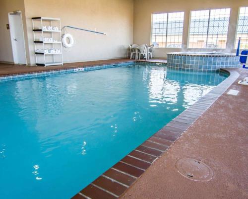 a large pool with blue water in a building at Sleep Inn & Suites Shreveport West in Shreveport