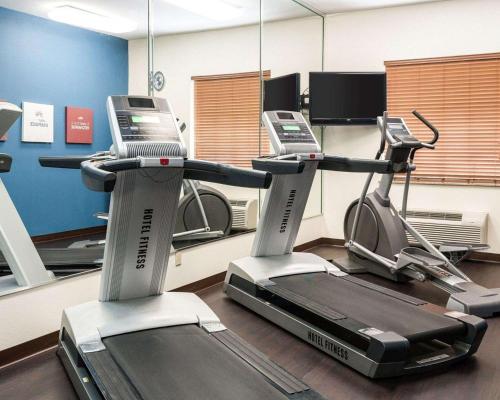a gym with two exercise bikes and a treadmill at Comfort Suites Oil Center in Lafayette