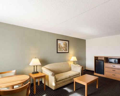 a hotel room with a couch and a tv at Sunrise Inn & Suites New Orleans in New Orleans