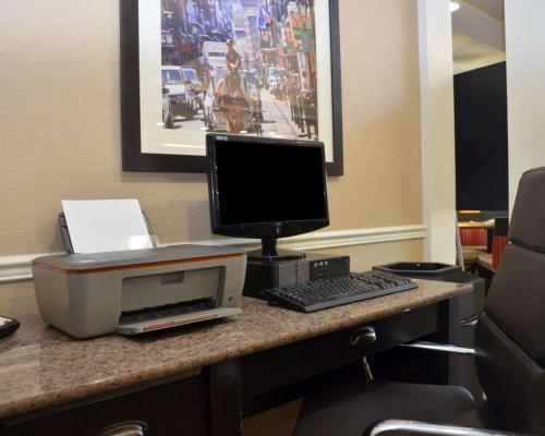 a desk with a computer and a monitor and keyboard at Comfort Inn West Monroe near Sports & Events Center in West Monroe