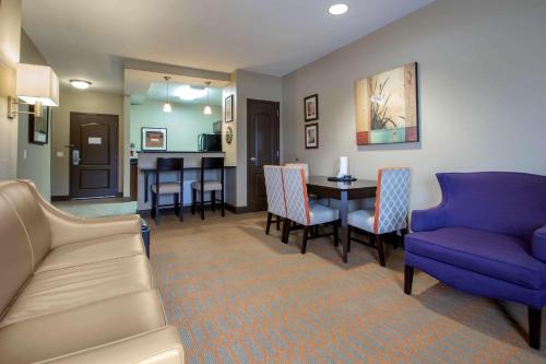 a living room with a couch and a table and chairs at Bluegreen Vacations Odyssey Dells Resort in Wisconsin Dells