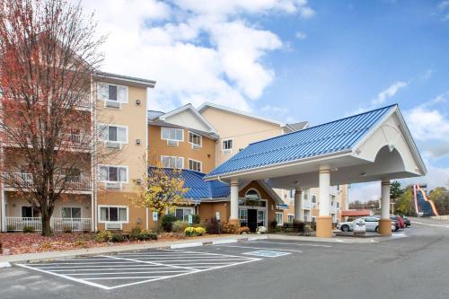 a building with a blue solar roof in a parking lot at Bluegreen Vacations Odyssey Dells Resort in Wisconsin Dells