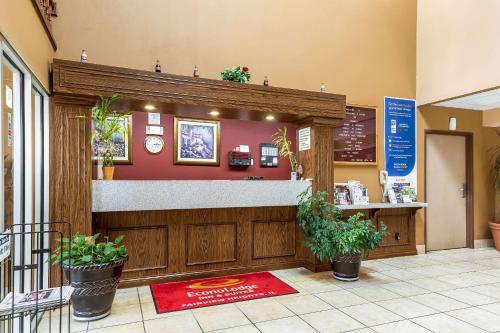 a fast food restaurant with a counter and potted plants at Econo Lodge Inn & Suites Fairview Heights St Louis in Fairview Heights