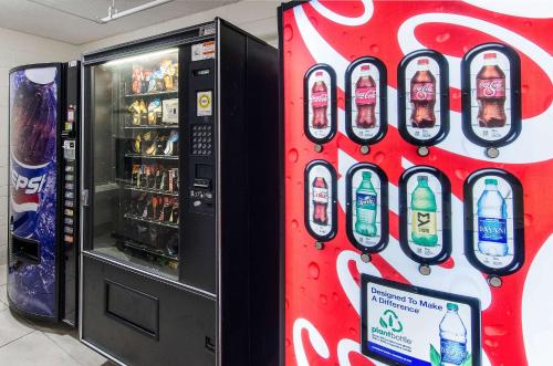 a coca cola vending machine next to a soda machine at Econo Lodge Inn & Suites in Norton