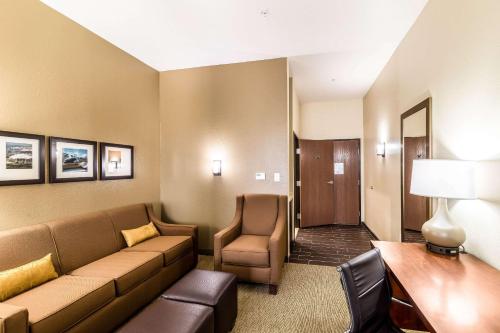 a living room with a couch and a chair in a room at Comfort Suites Grand Prairie - Arlington North in Grand Prairie