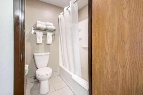 a bathroom with a toilet and a shower with towels at Quality Inn Madison West Near University Area in Madison