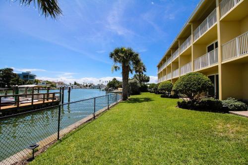 a view of a hotel with a river and a fence at Treasure Island Hotel and Marina in St Pete Beach