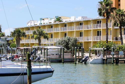 a marina with boats docked in front of a hotel at Treasure Island Hotel and Marina in St Pete Beach