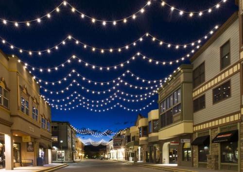 a street with lights hanging over a city at night at The Inn at Riverwalk in Edwards