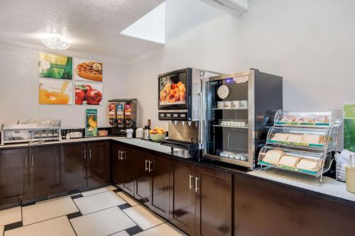 a kitchen with a counter with a refrigerator at Quality Inn & Suites Albuquerque North near Balloon Fiesta Park in Albuquerque