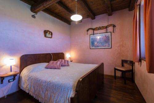 Postel nebo postele na pokoji v ubytování Agriturismo Borg da Ocjs