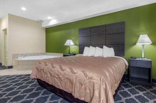 a hotel room with a bed and a bath tub at Quality Inn in Kingstree