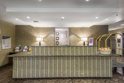 a lobby of a hotel with a reception counter at Comfort Suites in Saskatoon