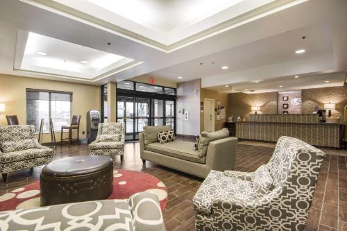 a lobby with chairs and a couch and a table at Comfort Suites in Saskatoon