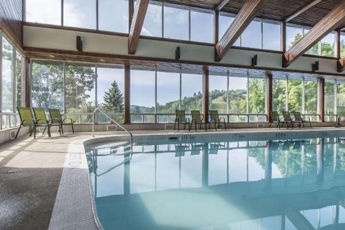 a swimming pool in a building with windows at Hidden Valley Resort, Ascend Hotel Collection in Huntsville