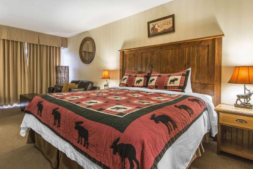 a bedroom with a bed and a dresser at Hidden Valley Resort, Ascend Hotel Collection in Huntsville