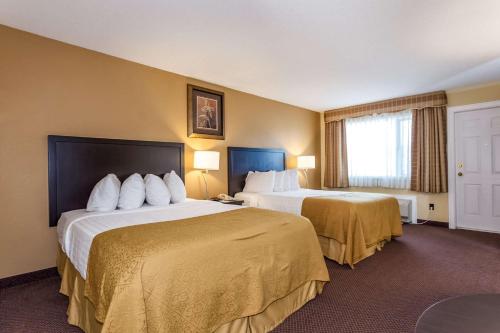 A bed or beds in a room at Quality Inn Merritt