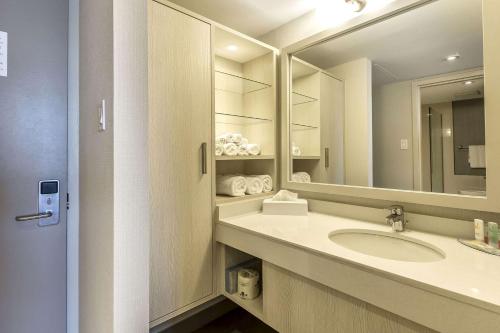 a bathroom with a sink and a mirror at Quality Inn Corner Brook in Corner Brook
