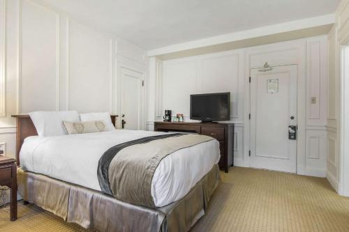 a bedroom with a large bed and a flat screen tv at Digby Pines Golf Resort and Spa in Digby