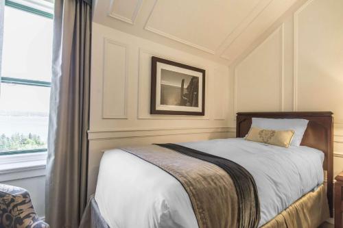 a bedroom with a bed and a window at Digby Pines Golf Resort and Spa in Digby
