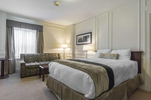 a hotel room with a large bed and a chair at Digby Pines Golf Resort and Spa in Digby