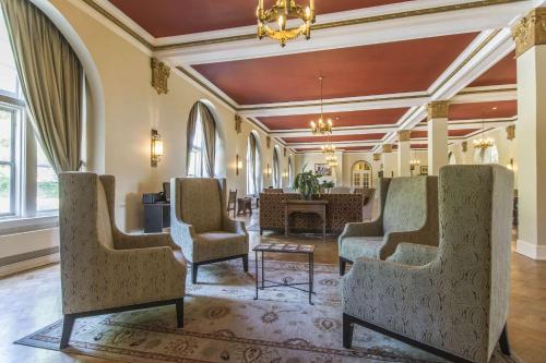 a lobby with chairs and a table and a chandelier at Digby Pines Golf Resort and Spa in Digby