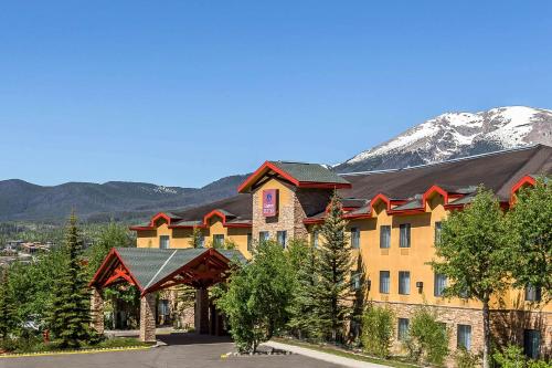 a resort building with a mountain in the background at Comfort Suites Summit County in Dillon