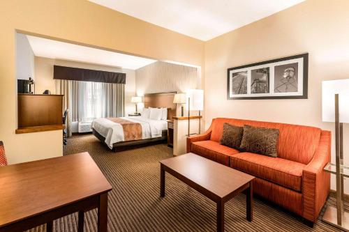 Quality Inn & Suites University Fort Collins في فورت كولينز: غرفة في الفندق مع أريكة وسرير