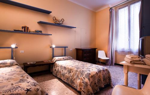 a bedroom with two beds and a window at Casa Costa Classica in Genova