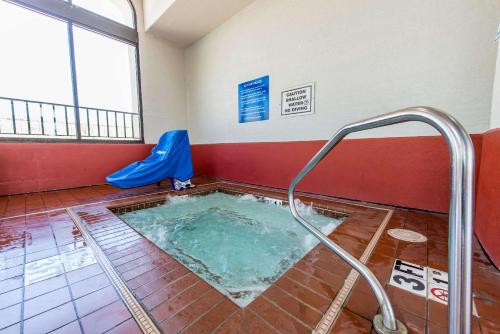 a hot tub with a hose in a room at Quality Inn Colorado Springs South in Colorado Springs