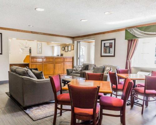a living room with chairs and tables and a couch at Quality Inn & Suites Golden - Denver West in Lakewood