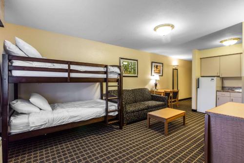 a room with two bunk beds and a chair at Quality Inn and Suites Summit County in Silverthorne