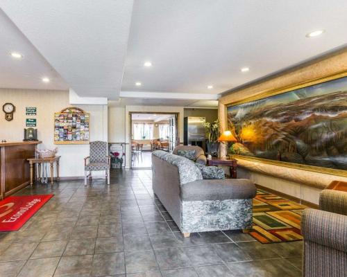 a living room with a couch and a painting on the wall at West End Lodge in Pagosa Springs
