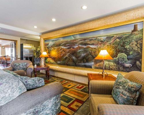 a living room with a large painting on the wall at West End Lodge in Pagosa Springs