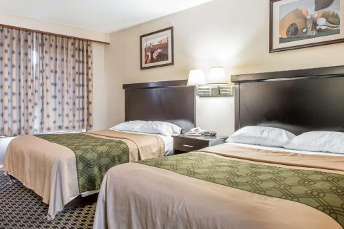 a hotel room with two beds and a window at Econo Lodge in West Haven
